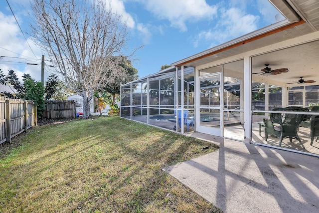 view of yard with a fenced in pool, a patio, and glass enclosure