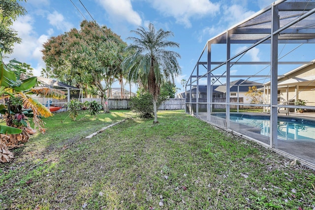 view of yard with a fenced in pool and a lanai