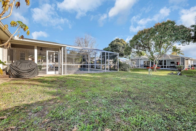 view of yard with glass enclosure