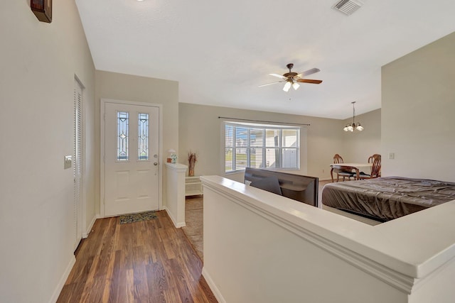 living room featuring dark wood-type flooring and ceiling fan