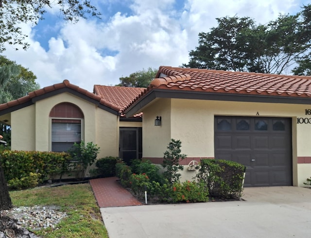 mediterranean / spanish house featuring a garage