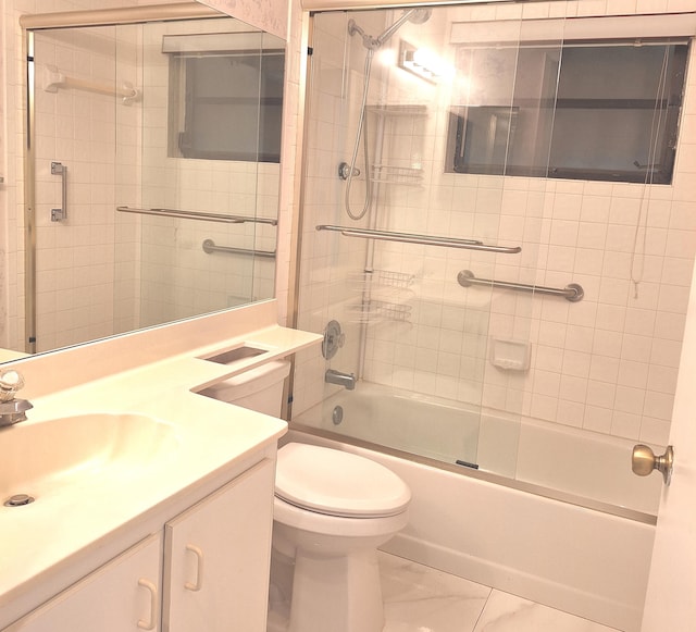 full bathroom with vanity, toilet, and combined bath / shower with glass door