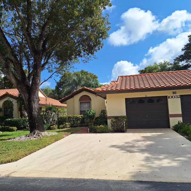 mediterranean / spanish home with a garage