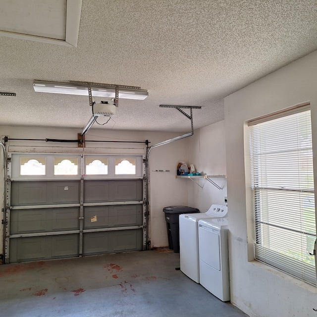 garage with a garage door opener and washer and clothes dryer