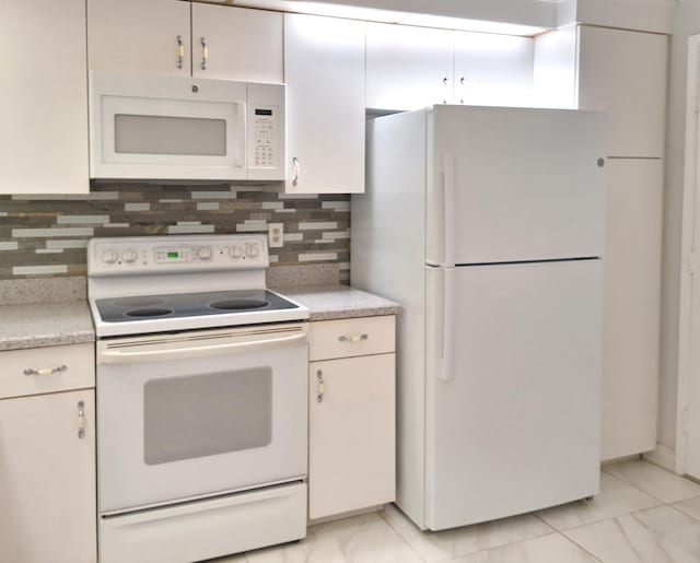 kitchen featuring tasteful backsplash and white appliances