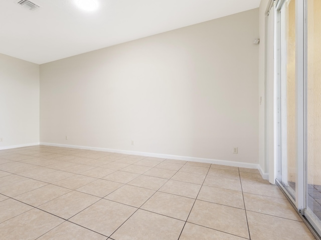 unfurnished room with light tile patterned flooring