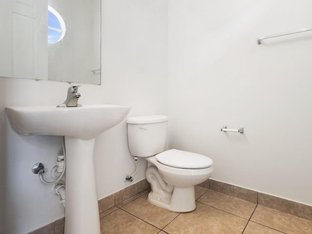 bathroom featuring toilet and tile patterned flooring