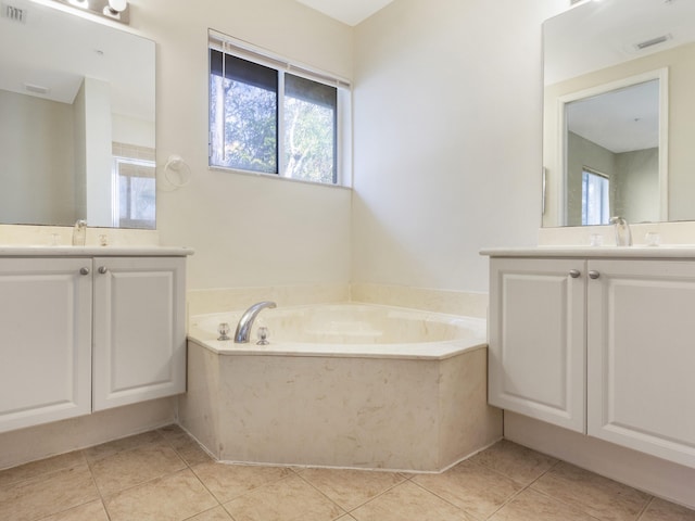 bathroom featuring vanity, a tub to relax in, and tile patterned floors