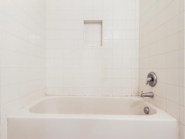 bathroom with a tub to relax in