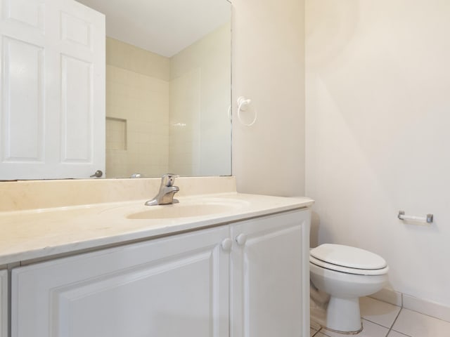 bathroom with tile patterned flooring, vanity, and toilet