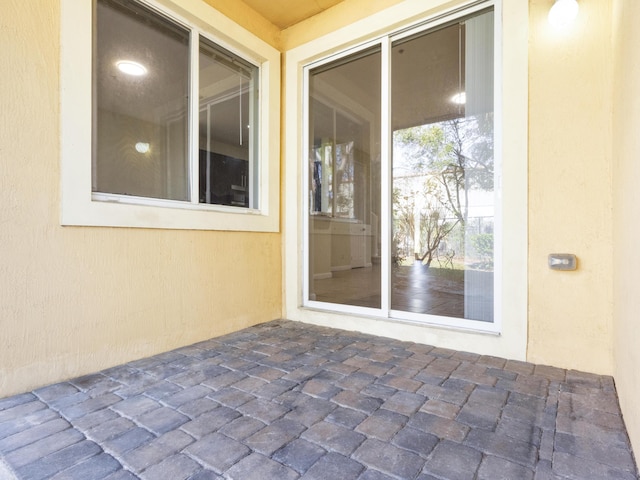 entrance to property featuring a patio