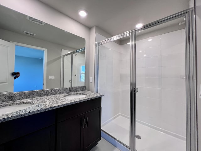 bathroom with an enclosed shower and vanity