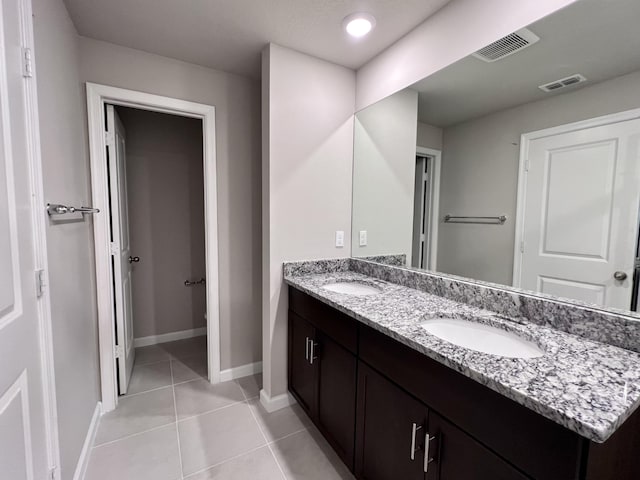 bathroom with tile patterned floors and vanity