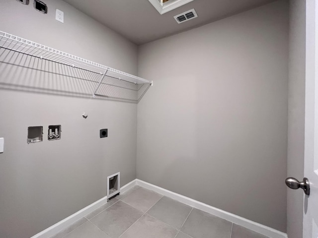 washroom featuring light tile patterned flooring, washer hookup, hookup for an electric dryer, and hookup for a gas dryer