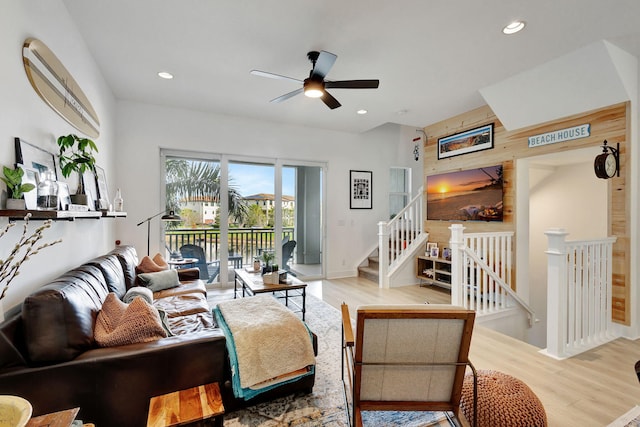 living room with ceiling fan and light hardwood / wood-style flooring