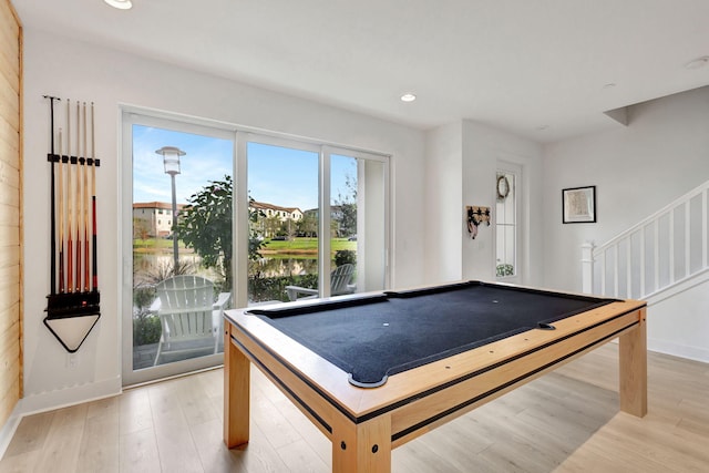 recreation room featuring pool table, light hardwood / wood-style floors, and a water view