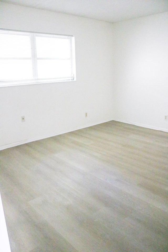 spare room featuring light hardwood / wood-style floors