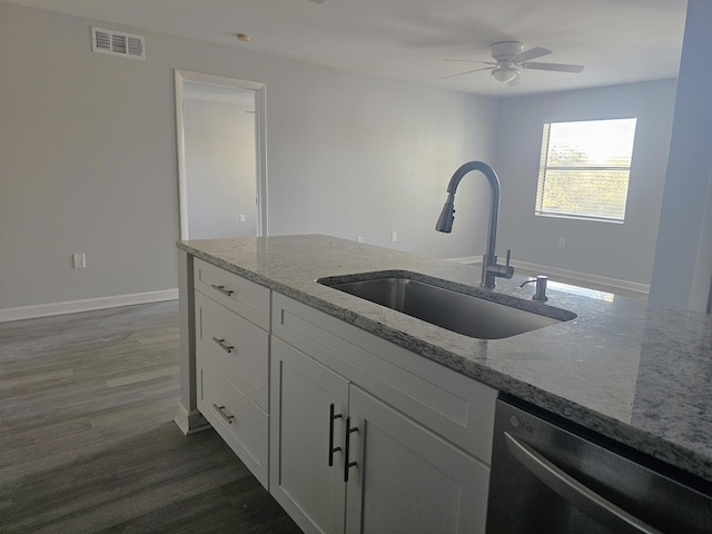 kitchen featuring light stone counters, sink, white cabinets, and dishwasher