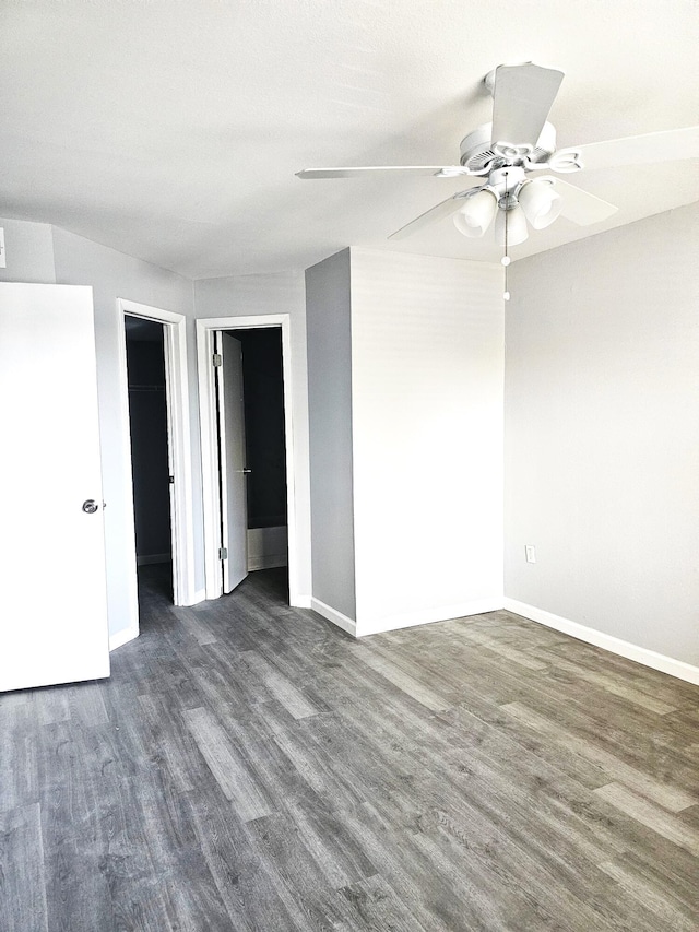 spare room featuring ceiling fan and dark hardwood / wood-style flooring