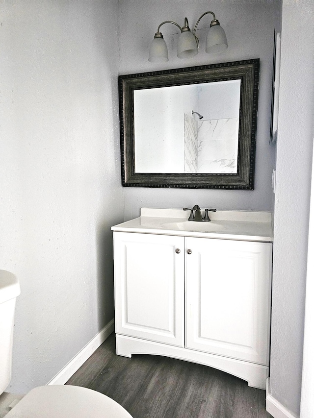 bathroom with vanity, hardwood / wood-style floors, and toilet