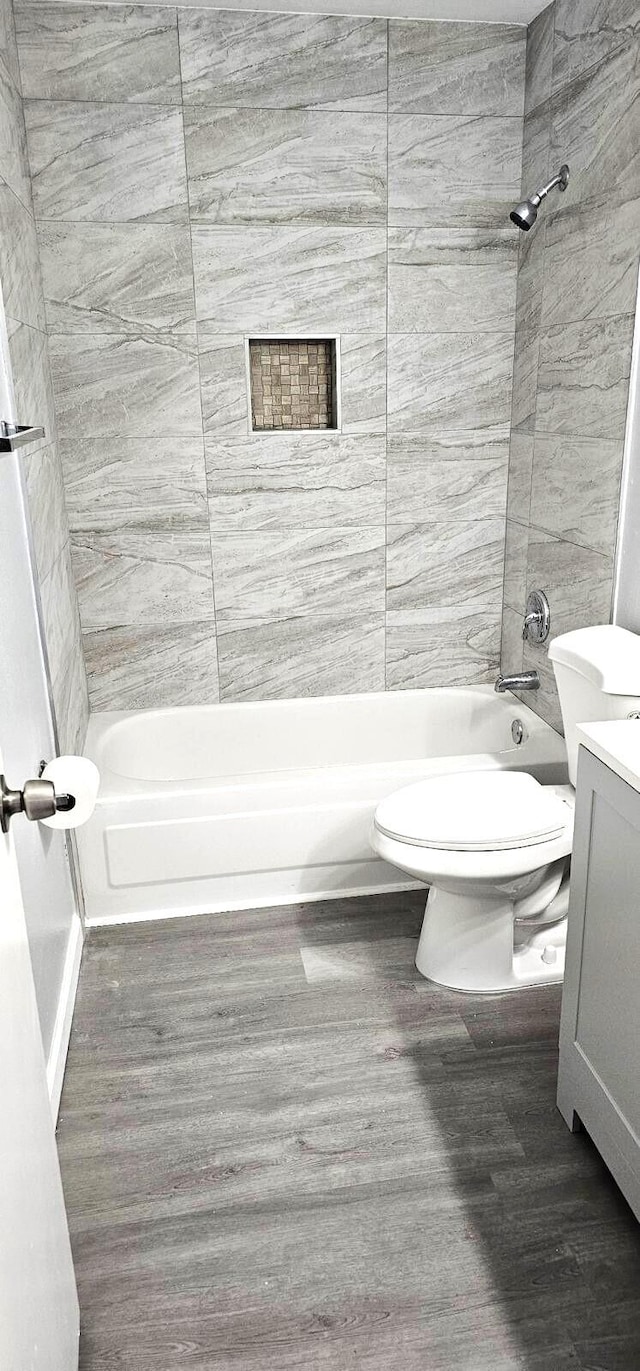 bathroom featuring vanity, wood-type flooring, and toilet