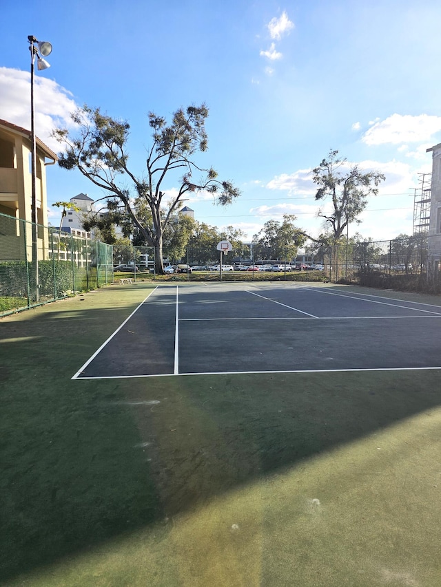 view of tennis court featuring basketball court