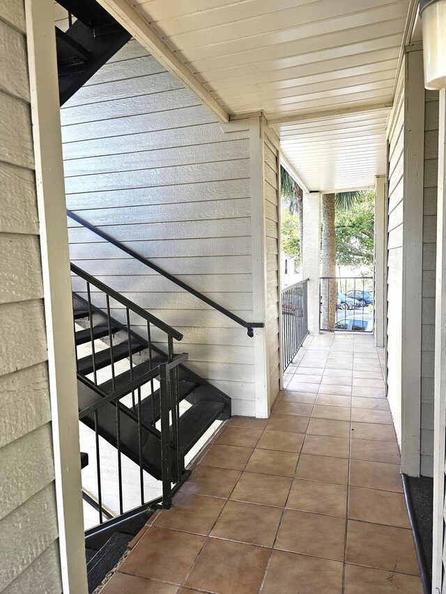 details with light stone counters, stainless steel dishwasher, white cabinets, and light wood-type flooring