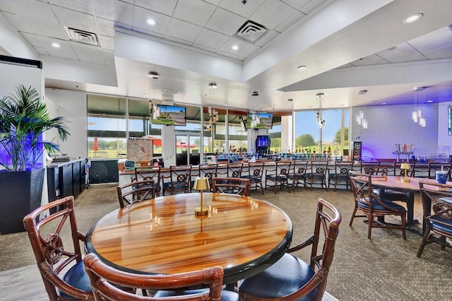 dining space with a paneled ceiling