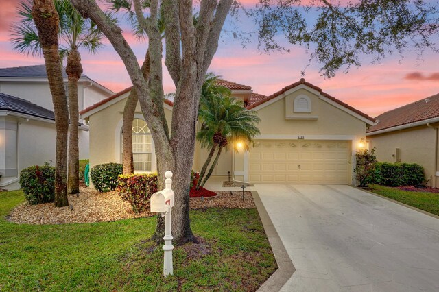 view of front of property featuring a garage and a front yard