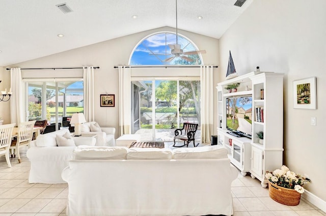 tiled living room with a textured ceiling, vaulted ceiling, and ceiling fan