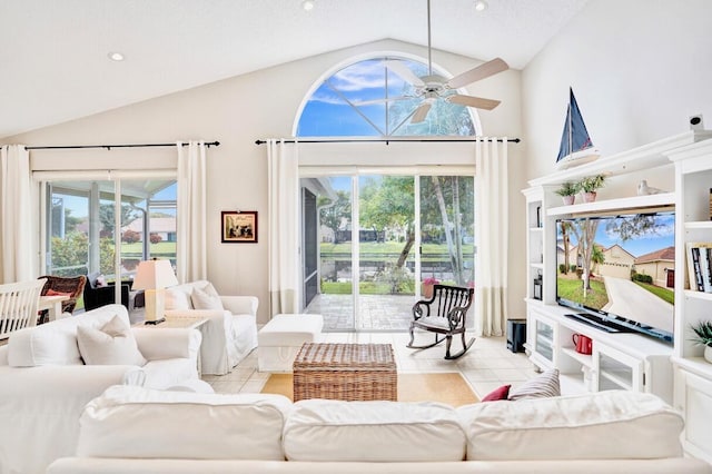 tiled living room with lofted ceiling, plenty of natural light, and ceiling fan