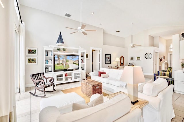 tiled living room featuring ceiling fan, plenty of natural light, and high vaulted ceiling