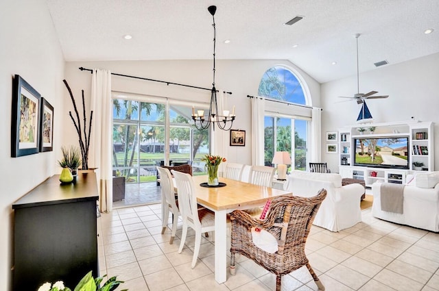 dining space featuring ceiling fan with notable chandelier, vaulted ceiling, a textured ceiling, and light tile patterned flooring