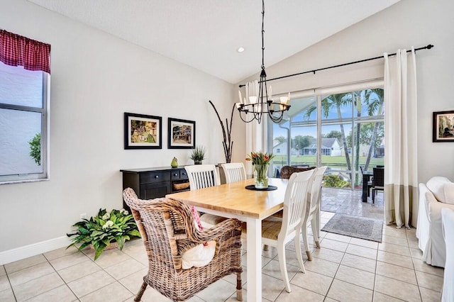 tiled dining space with vaulted ceiling and an inviting chandelier