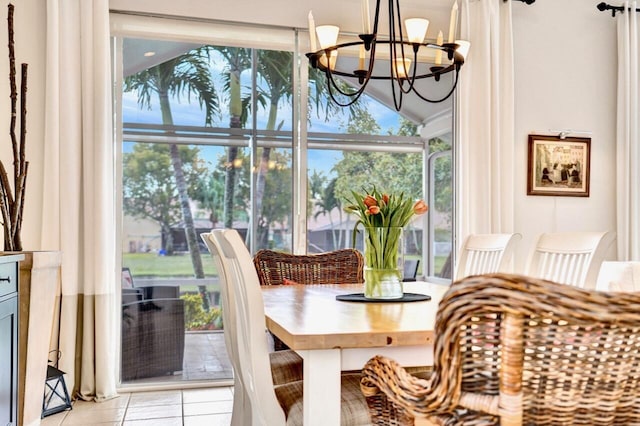 dining room with light tile patterned floors and a notable chandelier