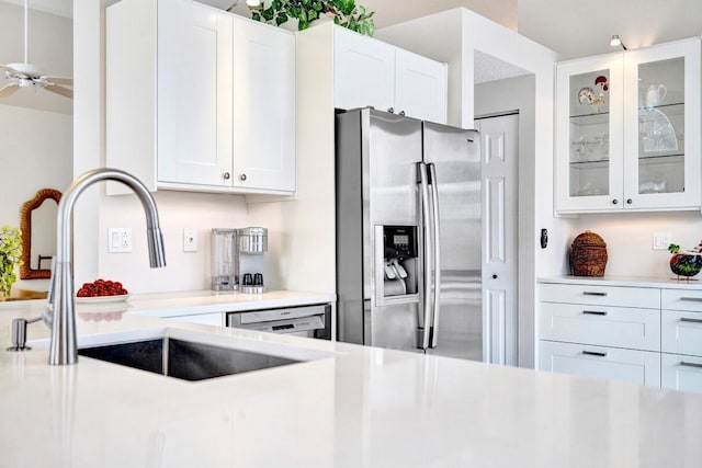 kitchen featuring sink, stainless steel fridge, white dishwasher, ceiling fan, and white cabinets