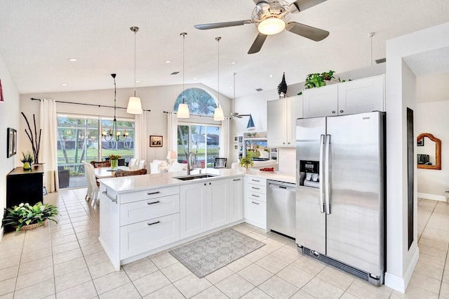 kitchen with stainless steel appliances, decorative light fixtures, sink, and white cabinets