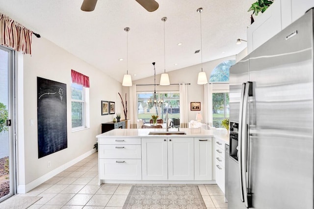 kitchen with light tile patterned flooring, sink, white cabinetry, decorative light fixtures, and stainless steel fridge with ice dispenser