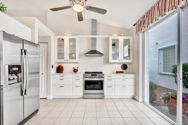 kitchen featuring lofted ceiling, white cabinets, wall chimney exhaust hood, and appliances with stainless steel finishes