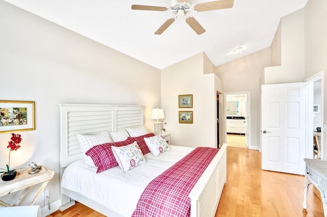 bedroom with ceiling fan, lofted ceiling, and light hardwood / wood-style flooring