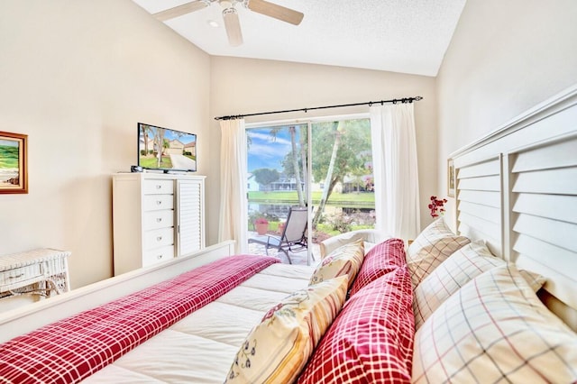 bedroom featuring ceiling fan, lofted ceiling, access to exterior, and a textured ceiling