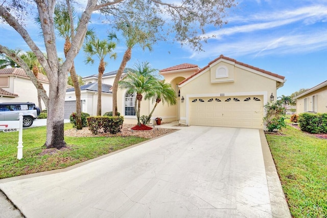 mediterranean / spanish house with a garage and a front yard