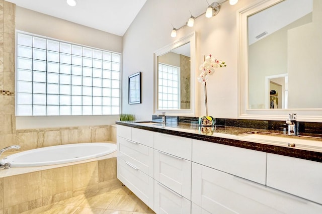 bathroom with vanity, tiled bath, and tile patterned floors