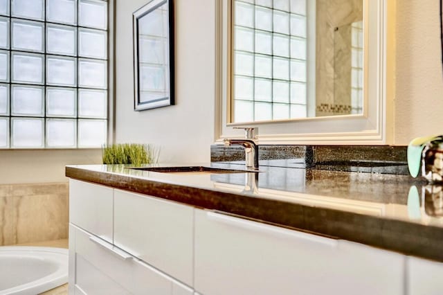 bathroom featuring vanity and a tub