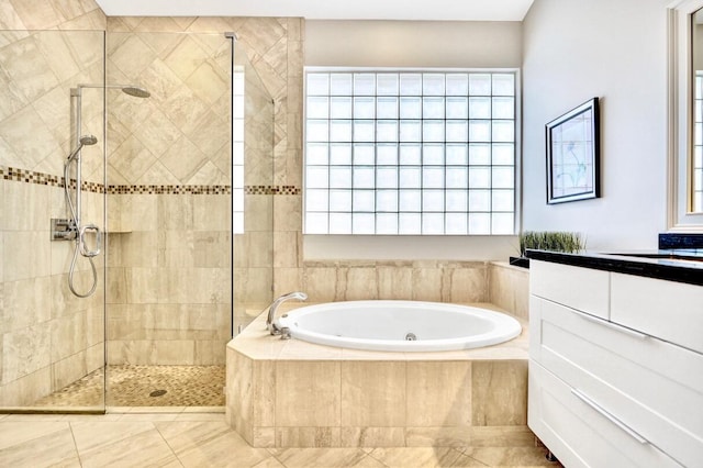 bathroom featuring vanity, a wealth of natural light, and plus walk in shower