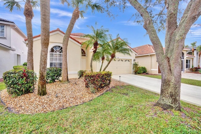 view of front of property with a garage and a front lawn