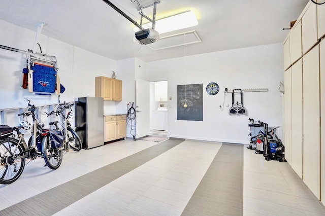 garage with washer / clothes dryer, a garage door opener, and stainless steel fridge