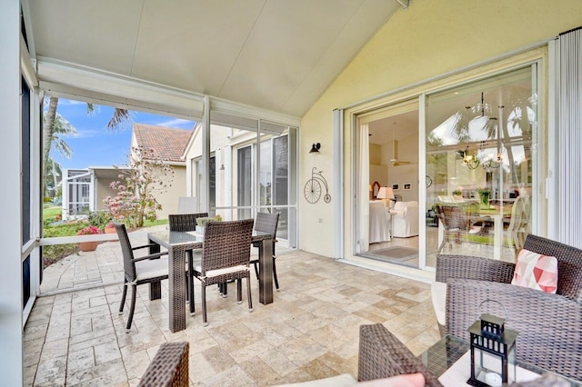 sunroom / solarium featuring lofted ceiling and an inviting chandelier