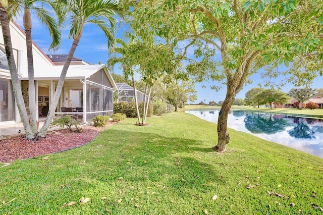 view of yard with a water view and a lanai