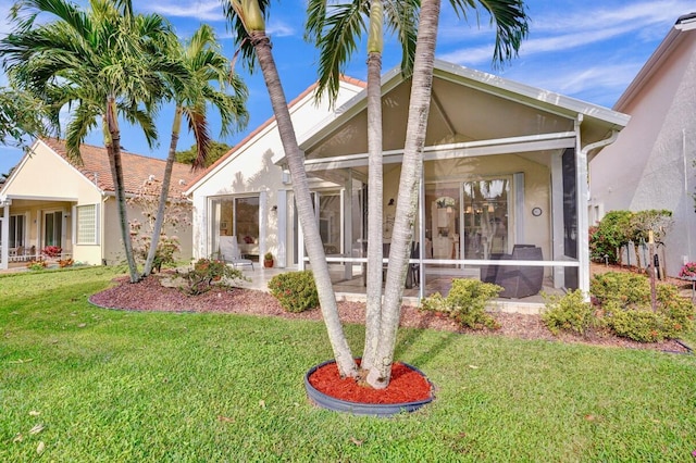 view of front of home with a front lawn and a sunroom